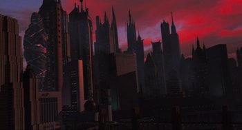 Movie still from “Batman Forever” (1995), directed by Joel Schumacher – A view of a city skyline at sunset; Extreme Wide shot, Low angle
