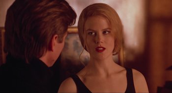 Movie still from “Batman Forever” (1995), directed by Joel Schumacher – A man and a woman are looking at each other; Close Up shot, Over the shoulder angle