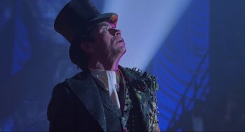 Movie still from “Batman Forever” (1995), directed by Joel Schumacher – A person wearing a top hat; Close Up shot, Low angle