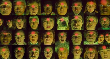 Movie still from “Batman Forever” (1995), directed by Joel Schumacher – A bunch of people with red lights on their faces; Close Up shot, Overhead angle