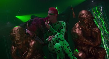 Movie still from “Batman Forever” (1995), directed by Joel Schumacher – A group of people dressed up in costumes; Medium shot, Low angle