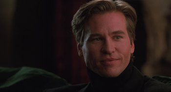 Movie still from “Batman Forever” (1995), directed by Joel Schumacher – A person wearing a black shirt; Close Up shot, Over the shoulder angle