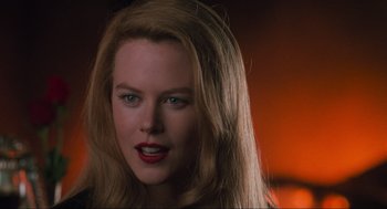 Movie still from “Batman Forever” (1995), directed by Joel Schumacher – A person with long hair; Close Up shot, Over the shoulder angle