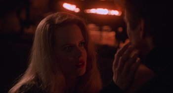 Movie still from “Batman Forever” (1995), directed by Joel Schumacher – A woman with red lipstick is looking at a man; Close Up shot, Over the shoulder angle