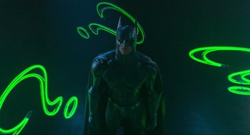 Movie still from “Batman Forever” (1995), directed by Joel Schumacher – A man dressed as a batman standing in the dark; Medium shot, Low angle