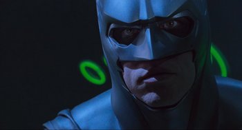 Movie still from “Batman Forever” (1995), directed by Joel Schumacher – A person wearing a blue costume; Close Up shot, Low angle