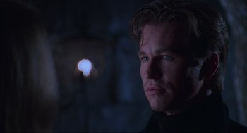 Movie still from “Batman Forever” (1995), directed by Joel Schumacher – A person wearing a black shirt; Close Up shot, Over the shoulder angle