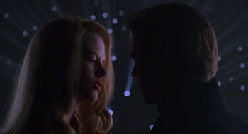 Movie still from “Batman Forever” (1995), directed by Joel Schumacher – A man and a woman face to face in the dark; Close Up shot, Low angle