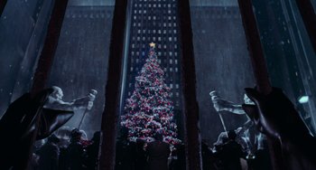 Movie still from “Batman Returns” (1992), directed by Tim Burton – A christmas tree is lit up in the middle of a building; Extreme Wide shot, Low angle