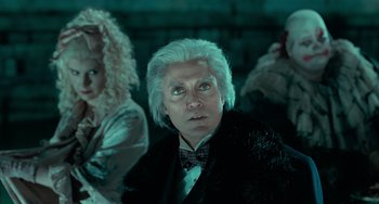 Movie still from “Batman Returns” (1992), directed by Tim Burton – A man with white hair is looking at the camera; Close Up shot, Low angle