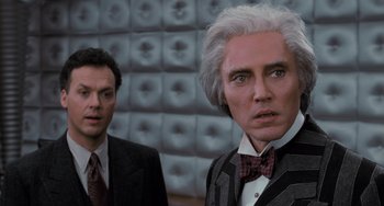 Movie still from “Batman Returns” (1992), directed by Tim Burton – Two men dressed in suits and bow ties; Close Up shot, Low angle