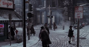 Movie still from “Batman Returns” (1992), directed by Tim Burton – A group of people walking down a street in the snow; Extreme Wide shot, High angle