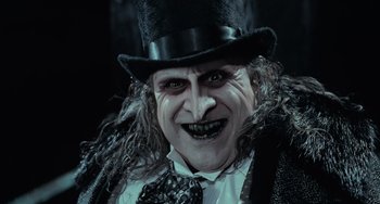 Movie still from “Batman Returns” (1992), directed by Tim Burton – A person wearing a top hat; Close Up shot, Low angle
