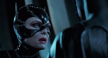 Movie still from “Batman Returns” (1992), directed by Tim Burton – A person wearing a costume; Close Up shot, Over the shoulder angle