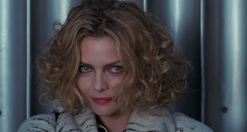 Movie still from “Batman Returns” (1992), directed by Tim Burton – A person with curly hair; Close Up shot, Over the shoulder angle