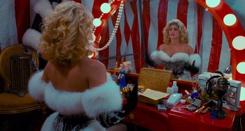 Movie still from “Batman Returns” (1992), directed by Tim Burton – A woman in a costume looking in a mirror; Medium shot, Over the shoulder angle