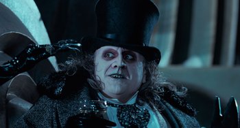 Movie still from “Batman Returns” (1992), directed by Tim Burton – A person wearing a top hat; Close Up shot, Low angle