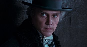 Movie still from “Batman Returns” (1992), directed by Tim Burton – A person wearing a hat; Close Up shot, Low angle