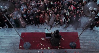 Movie still from “Batman Returns” (1992), directed by Tim Burton – A crowd of people standing on a red carpet; Extreme Wide shot, Overhead angle