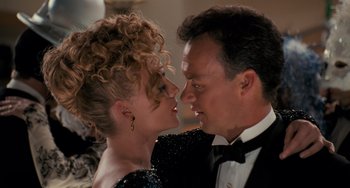 Movie still from “Batman Returns” (1992), directed by Tim Burton – A man and a woman in formal wear kissing; Close Up shot, Over the shoulder angle