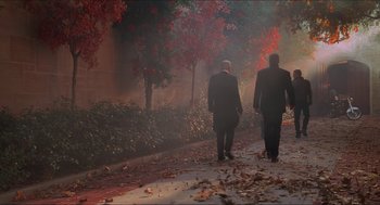 Movie still from “Batman & Robin” (1997), directed by Joel Schumacher – A couple of men walking down a sidewalk; Wide shot, High angle