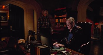 Movie still from “Batman & Robin” (1997), directed by Joel Schumacher – A man and a woman sitting in front of a computer; Medium shot, Over the shoulder angle