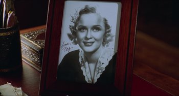 Movie still from “Batman & Robin” (1997), directed by Joel Schumacher – An old photo of a woman in a wooden frame; Close Up shot, High angle