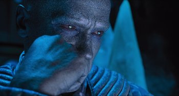 Movie still from “Batman & Robin” (1997), directed by Joel Schumacher – A man's face with blue paint on his face; Close Up shot, Over the shoulder angle