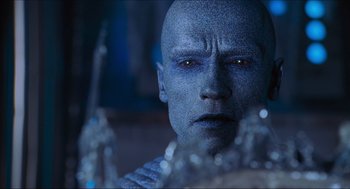 Movie still from “Batman & Robin” (1997), directed by Joel Schumacher – A man's face in front of a glass sculpture; Close Up shot, Over the shoulder angle