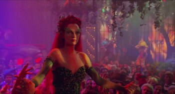 Movie still from “Batman & Robin” (1997), directed by Joel Schumacher – A woman dressed as poison ivy at a halloween party; Medium shot, Over the shoulder angle