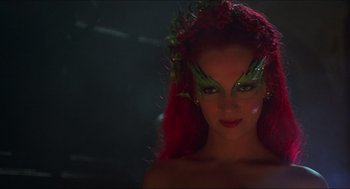 Movie still from “Batman & Robin” (1997), directed by Joel Schumacher – A woman with red hair and green makeup; Close Up shot, Over the shoulder angle