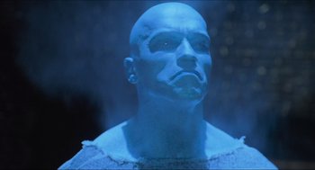 Movie still from “Batman & Robin” (1997), directed by Joel Schumacher – A man with a bald head is looking at the camera; Close Up shot, Low angle