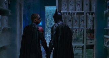 Movie still from “Batman & Robin” (1997), directed by Joel Schumacher – A couple of men holding hands in a room; Medium shot, Over the shoulder angle