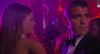 Movie still from “Batman & Robin” (1997), directed by Joel Schumacher – A man and a woman are standing in a room; Close Up shot, Over the shoulder angle