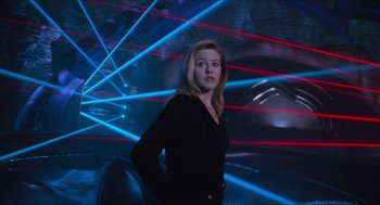 Movie still from “Batman & Robin” (1997), directed by Joel Schumacher – A woman standing in front of a wall of lights; Medium shot, Low angle