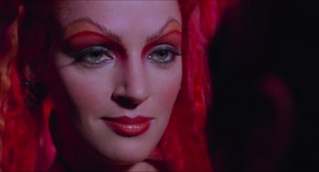 Movie still from “Batman & Robin” (1997), directed by Joel Schumacher – A person with makeup on; Close Up shot, Over the shoulder angle