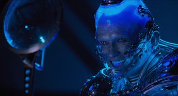 Movie still from “Batman & Robin” (1997), directed by Joel Schumacher – An image of a man that is smiling for the camera; Close Up shot, Low angle