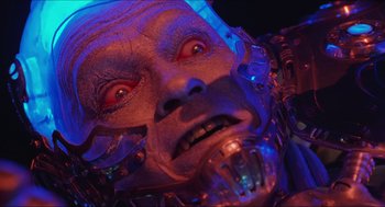Movie still from “Batman & Robin” (1997), directed by Joel Schumacher – A person's face in blue light; Close Up shot, Low angle