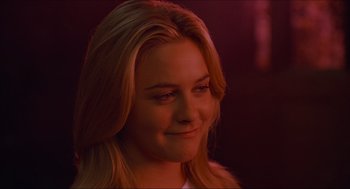 Movie still from “Batman & Robin” (1997), directed by Joel Schumacher – A beautiful young lady with long blonde hair; Close Up shot, Over the shoulder angle