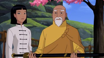 Movie still from “Batman: Soul of the Dragon” (2021), directed by Sam Liu – An old man and a young woman are standing together; Medium shot, Over the shoulder angle
