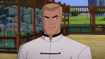 Movie still from “Batman: Soul of the Dragon” (2021), directed by Sam Liu – A man with a bald head wearing a white shirt; Medium shot, Over the shoulder angle