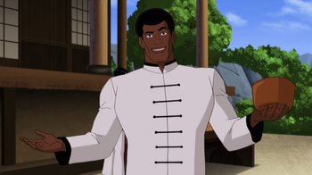Movie still from “Batman: Soul of the Dragon” (2021), directed by Sam Liu – A man wearing a white shirt and standing in front of a building; Medium shot, Over the shoulder angle