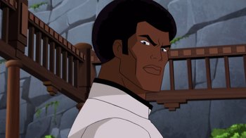 Movie still from “Batman: Soul of the Dragon” (2021), directed by Sam Liu – An animated picture of a man with a black hair style; Close Up shot, Over the shoulder angle