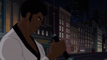 Movie still from “Batman: Soul of the Dragon” (2021), directed by Sam Liu – A man holding a microphone in front of a city street at night; Medium shot, Over the shoulder angle