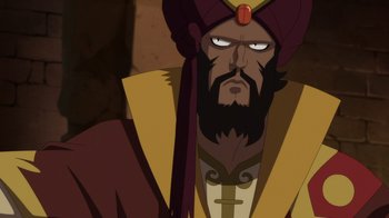 Movie still from “Batman: The Doom That Came to Gotham” (2023), directed by Sam Liu – An image of a man with a beard and a turban; Close Up shot, Over the shoulder angle