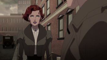 Movie still from “Batman: The Doom That Came to Gotham” (2023), directed by Sam Liu – A woman with red curly hair standing in front of a brick building; Medium shot, Over the shoulder angle