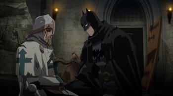 Movie still from “Batman: The Doom That Came to Gotham” (2023), directed by Sam Liu – Two men in a dark room , one of them wearing a batman costume; Wide shot, Over the shoulder angle