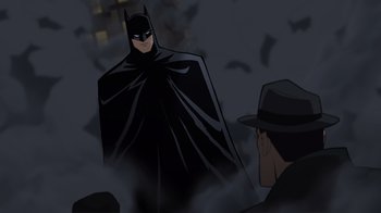 Movie still from “Batman: The Long Halloween” (2021), directed by Chris Palmer – A cartoon of a batman and a man in a hat; Medium shot, Over the shoulder angle