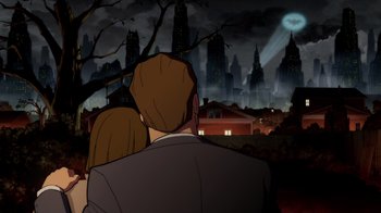 Movie still from “Batman: The Long Halloween” (2021), directed by Chris Palmer – A man and a woman looking at a city at night; Medium shot, Low angle