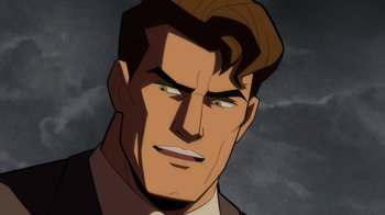 Movie still from “Batman: The Long Halloween” (2021), directed by Chris Palmer – A man with brown hair and green eyes is staring straight ahead; Close Up shot, High angle